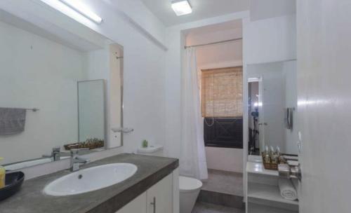 a white bathroom with a sink and a toilet at 519@jamtree in Colombo
