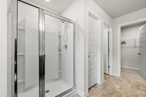 a walk in shower in a bathroom with white walls at MOONLIGHT HOLIDAY HOME in Durban