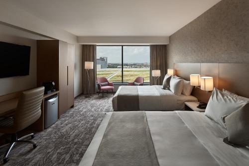 a hotel room with a large bed and a television at Great Canadian Casino Resort Toronto in Toronto