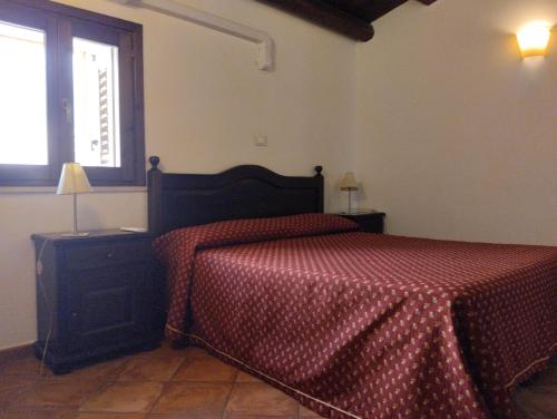 Ένα ή περισσότερα κρεβάτια σε δωμάτιο στο Agriturismo Masseria La Chiusa
