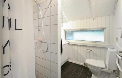 a bathroom with a toilet and a window at Lovely Home In Spttrup With House A Panoramic View in Spottrup