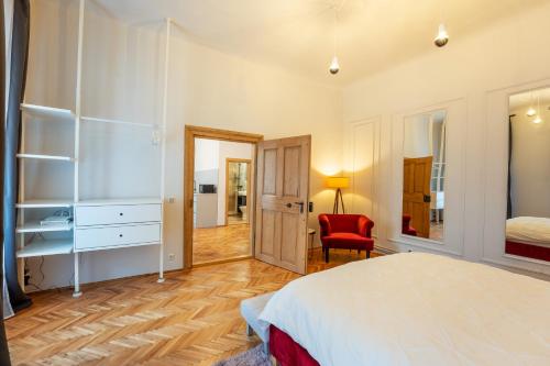 a bedroom with a bed and a desk and a chair at La Turn in Sighişoara
