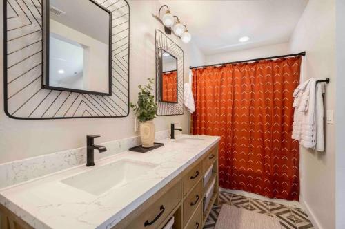 a bathroom with a sink and a large mirror at The Rock Trail House+Renovated+Modern+Fireplace+EV+Nice Yard in Flagstaff