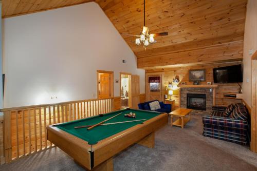 a living room with a pool table and a fireplace at 5 Mins to Pigeon Forge Strip w/ Hot Tub+Grill+MORE in Pigeon Forge