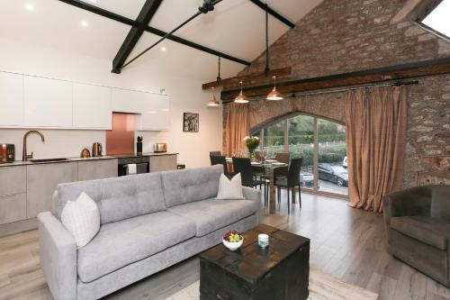 a living room with a couch and a table at Strawberry Line, Apartment 1 in Wells