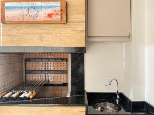 a kitchen with a sink and a counter at Villa Gaivotas - Balneário Piçarras in Piçarras