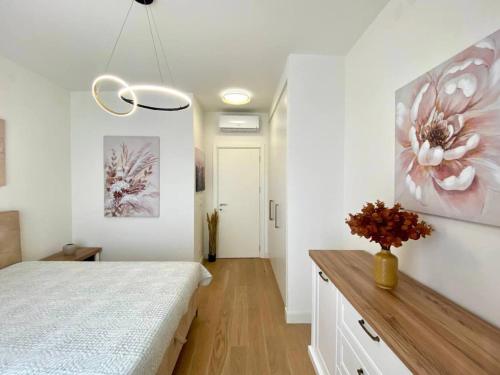 a bedroom with a bed and a flower painting on the wall at Bray Relax Home 3 in Farsala