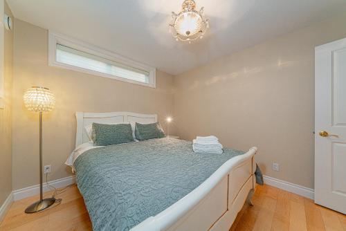 a bedroom with a bed and a chandelier at 38-Villa in Vancouver