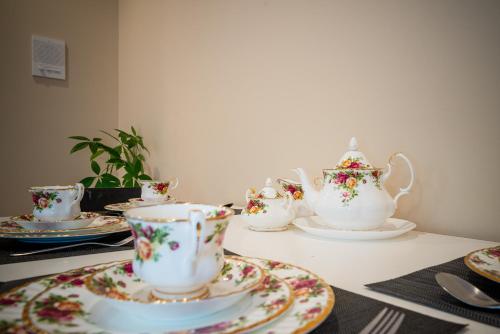 a group of tea cups and saucers on a table at 38-Villa in Vancouver