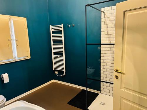 a blue bathroom with a shower and a toilet at Antica dimora in Borgo a Buggiano