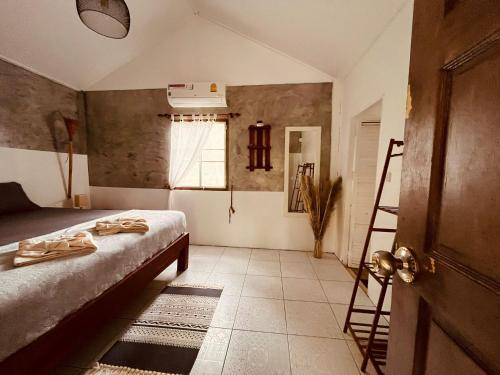 a bedroom with a bed and a ladder and a window at Villa Wonderworld Resort in Ban Nua