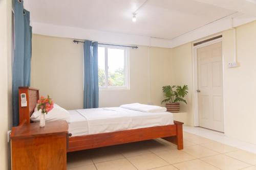 a bedroom with a bed and a window at Happy-Nest (First floor) in Marigot