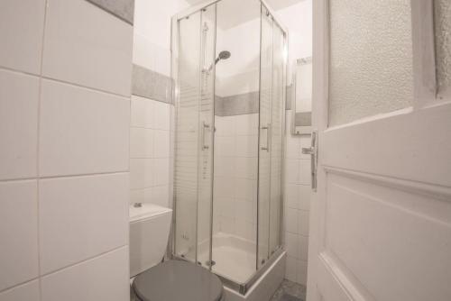 a bathroom with a toilet and a glass shower at Le botanica in Angers