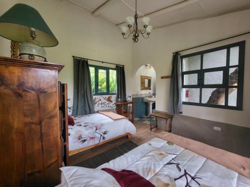 a bedroom with two beds and a window at Quinta Paolita in Tumbabiro