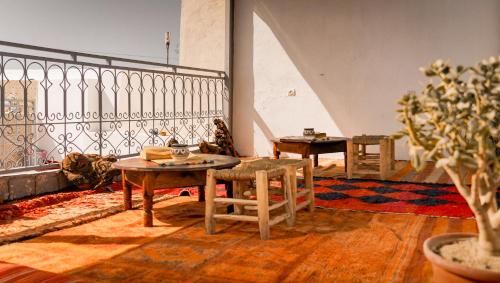 a living room with a table and chairs and a staircase at Soul Surf House Anza in Agadir