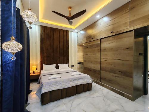 a bedroom with a bed and a ceiling fan at Lavish inn homestay in Mysore