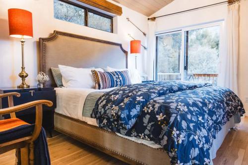 a bedroom with a bed with a blue and white comforter at The Sol Cottage+ Hiking+Creek Access+Views in Sedona