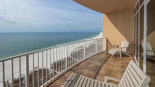 a balcony with two white benches and the ocean at Phoenix Orange Beach II 2003 in Orange Beach
