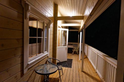 a room with a chair and a table on a porch at Autour de l'étang 86 in Bourbourg