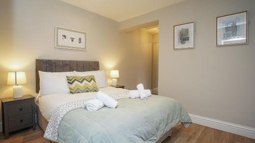 a bedroom with a bed with two towels on it at Modern 1 BDR City Apartments by Belfast City Breaks in Belfast