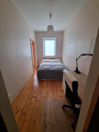 a bedroom with a bed and a desk in it at Savanorių pr. 3A in Kaunas