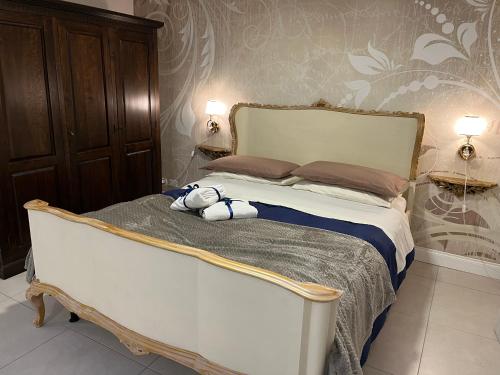 a teddy bear sitting on a bed in a bedroom at Casa de la Luna in Nettuno