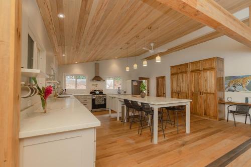 a kitchen with a table and chairs in a room at Sattva Land in Belmopan