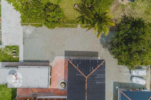 an overhead view of a building with a palm tree at Raizes AXM I Casa Campestre I Armenia, Quindío, Colombia in Armenia