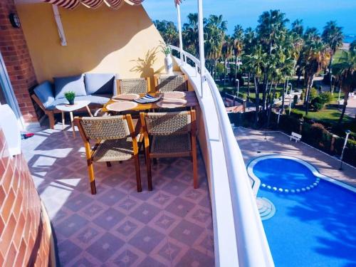 a patio with a table and chairs next to a pool at Los Cuentos De Natalia / The Tales Of Natalia in Oropesa del Mar