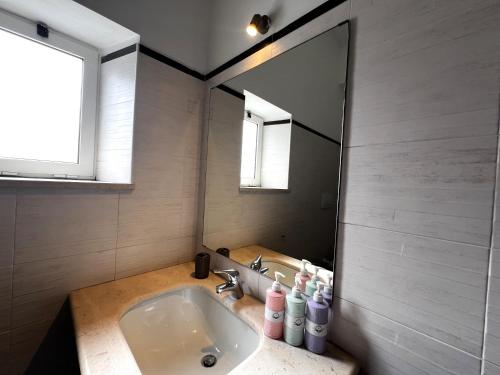 a bathroom with a sink and a large mirror at Welcome to Bari in Bari