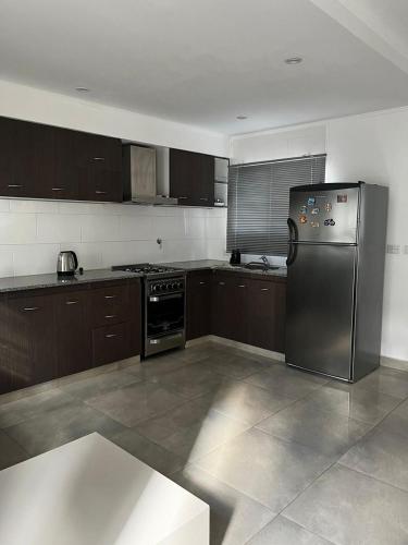 a kitchen with a stainless steel refrigerator and stove at Lo de pame y Fran in Tandil