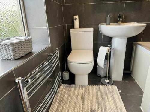 a bathroom with a toilet and a sink at Home in Sheffield with King/Twin bed in Longley