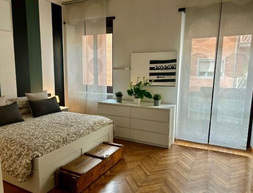 a bedroom with a bed and a glass shower at Santhry House in Turin