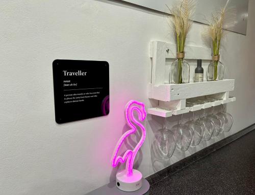 a pink flamingo is on a stand next to a wall at Santhry House in Turin