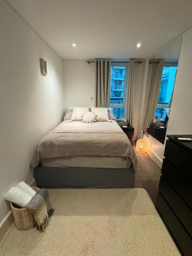 a bedroom with a bed and a large window at LondonEYE private bedroom in shared flat in London