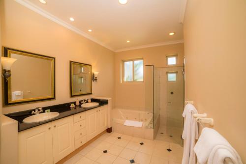 a bathroom with two sinks and a shower at Los Suenos Resort Bella Vista 2C in Herradura