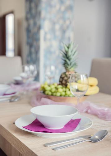 a table with a bowl and a plate of fruit at Grand Budapest Penthouse in Budapest