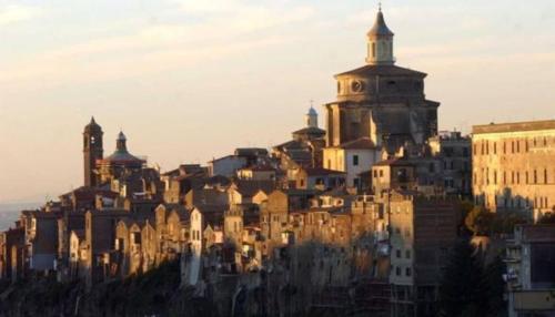 a building on top of a hill with buildings at Casetta centro storico in Zagarolo