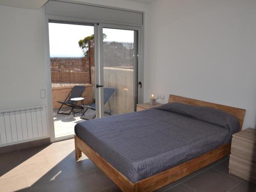 a bedroom with a bed and a sliding glass door at Villa Magnifica, L'Estartit - Centro - ES-323-46 in L'Estartit