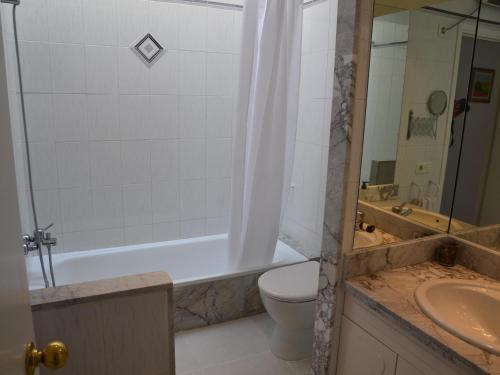 a bathroom with a toilet and a tub and a sink at Casa con Piscina y Cerca de la Playa en L'Estartit - ES-323-65 in L'Estartit