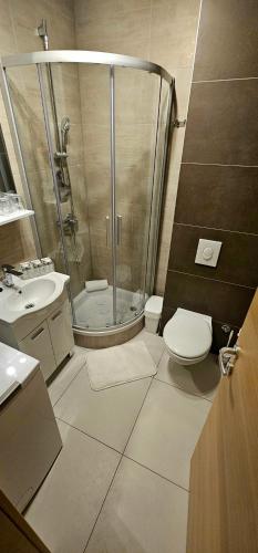a bathroom with a shower and a toilet and a sink at Split/Podstrana Apartment ADRIA in Podstrana