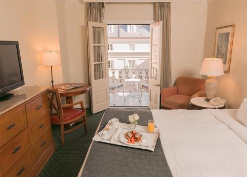 a hotel room with a tray of food on a bed at Maison Dupuy Hotel in New Orleans