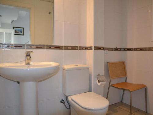 a white bathroom with a sink and a toilet at Casa Mediterranea - L'Estartit, Roca Maura - ES-323-70 in L'Estartit