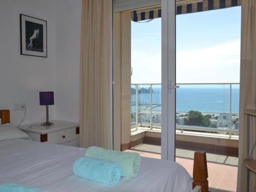 a bedroom with a bed and a view of the ocean at Casa Mediterranea - L'Estartit, Roca Maura - ES-323-70 in L'Estartit