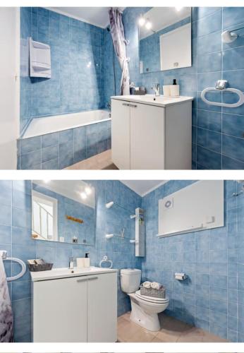 a blue bathroom with a sink and a toilet at Ca la Neus in Marçà