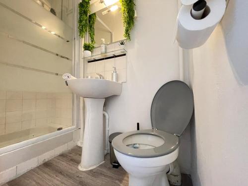 a white bathroom with a toilet and a sink at Little Good time in Marseille