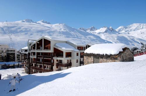 a building on top of a snow covered mountain at Résidence Odalys Le Hameau du Borsat in Tignes
