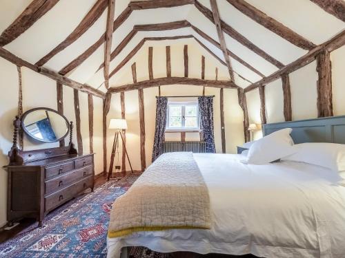 a bedroom with a bed and a mirror and a dresser at Dukes Lodge in Kersey