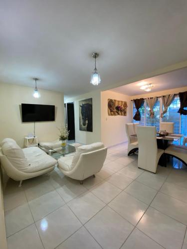 a living room with white furniture and a flat screen tv at Apartamento de Lujo Conjunto Marsella Real in Valledupar