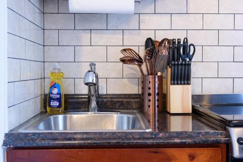 a kitchen counter with a sink and utensils at 69-5D Modern Lower East East 1br Apt BRAND NEW in New York